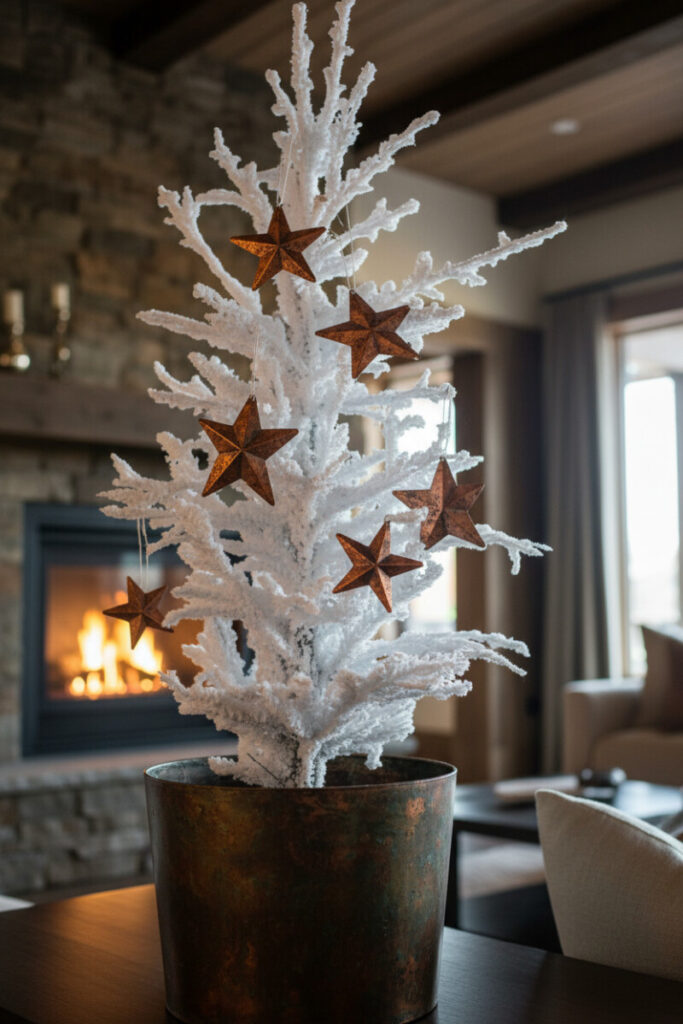 Tabletop flocked tree in a dark bronze planter featuring oversized rustic metal stars, roaring fire and wood beams softly blurred behind.