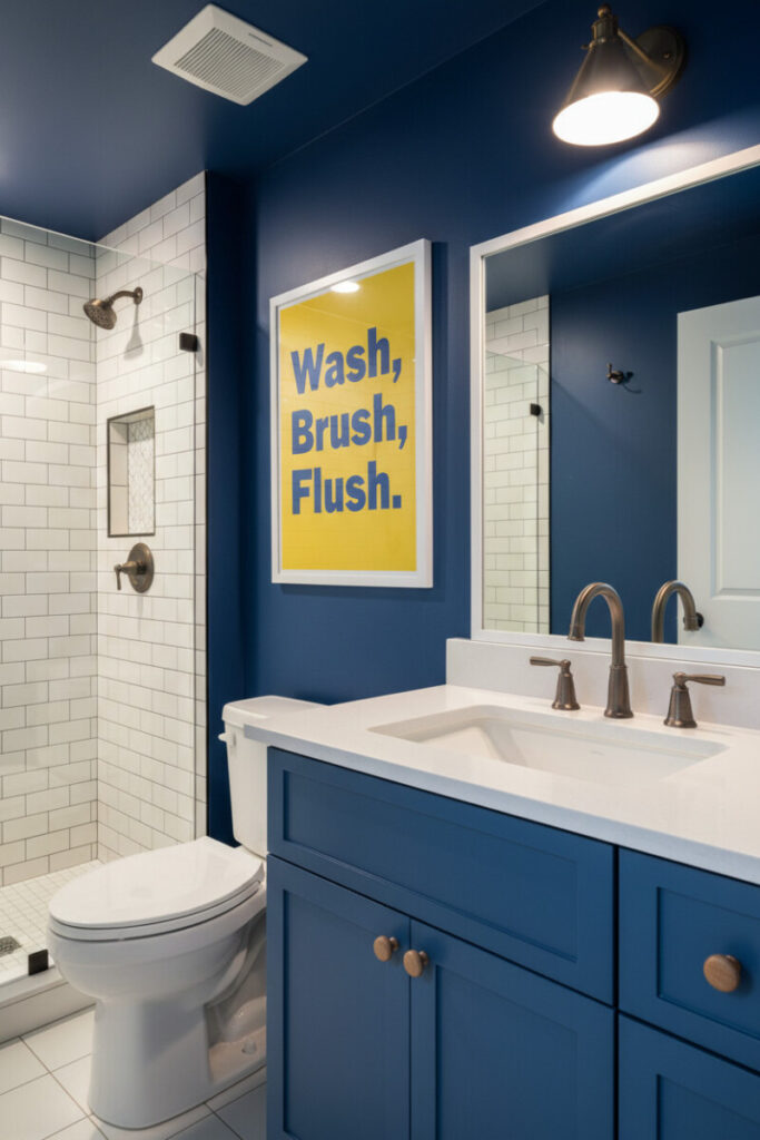 Cobalt blue accent wall and ceiling, framed “Wash, Brush, Flush.” poster, matte blue vanity—graphic Boys Bathroom Designs.