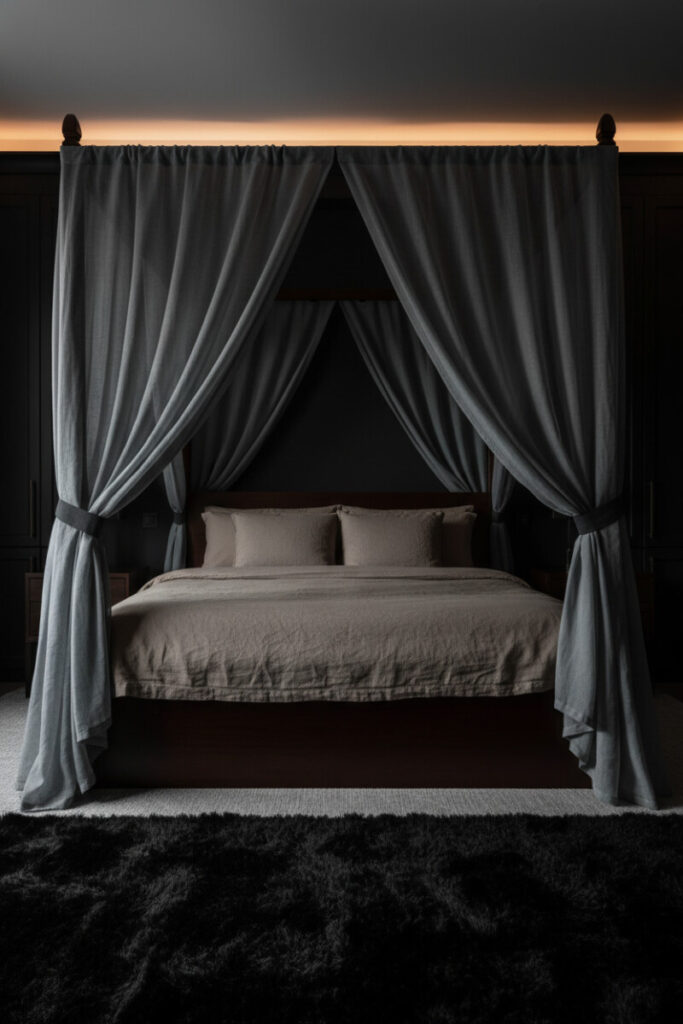 Dark mahogany four-poster with slate voile curtains, hidden cove lighting, taupe linen, and shaggy black rug—Soft Glow Sanctuary illustrating how to light a moody bedroom with indirect glow.