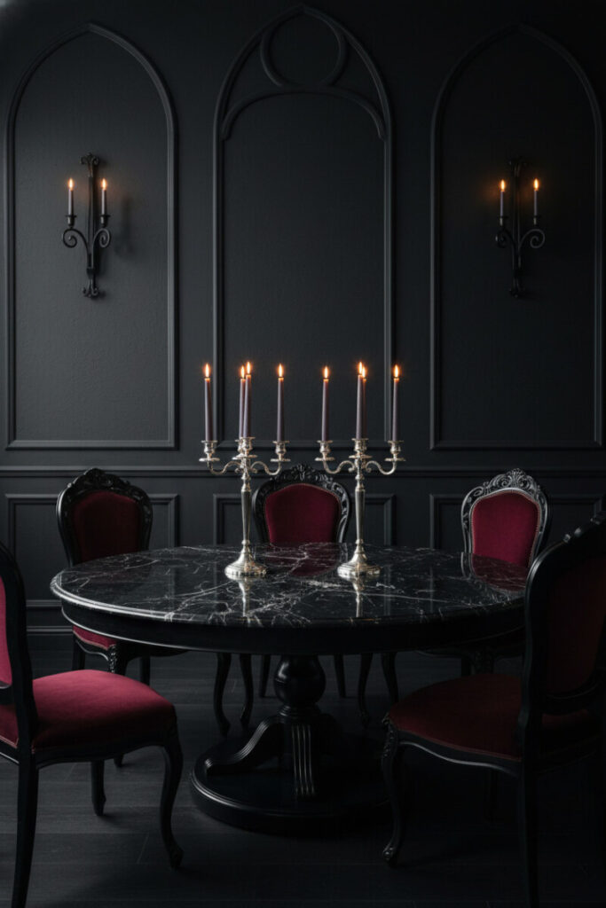 Black marble round table, crimson velvet Louis chairs, and sterling candelabras—Gothic Drama within Moody Dining Room Designs.